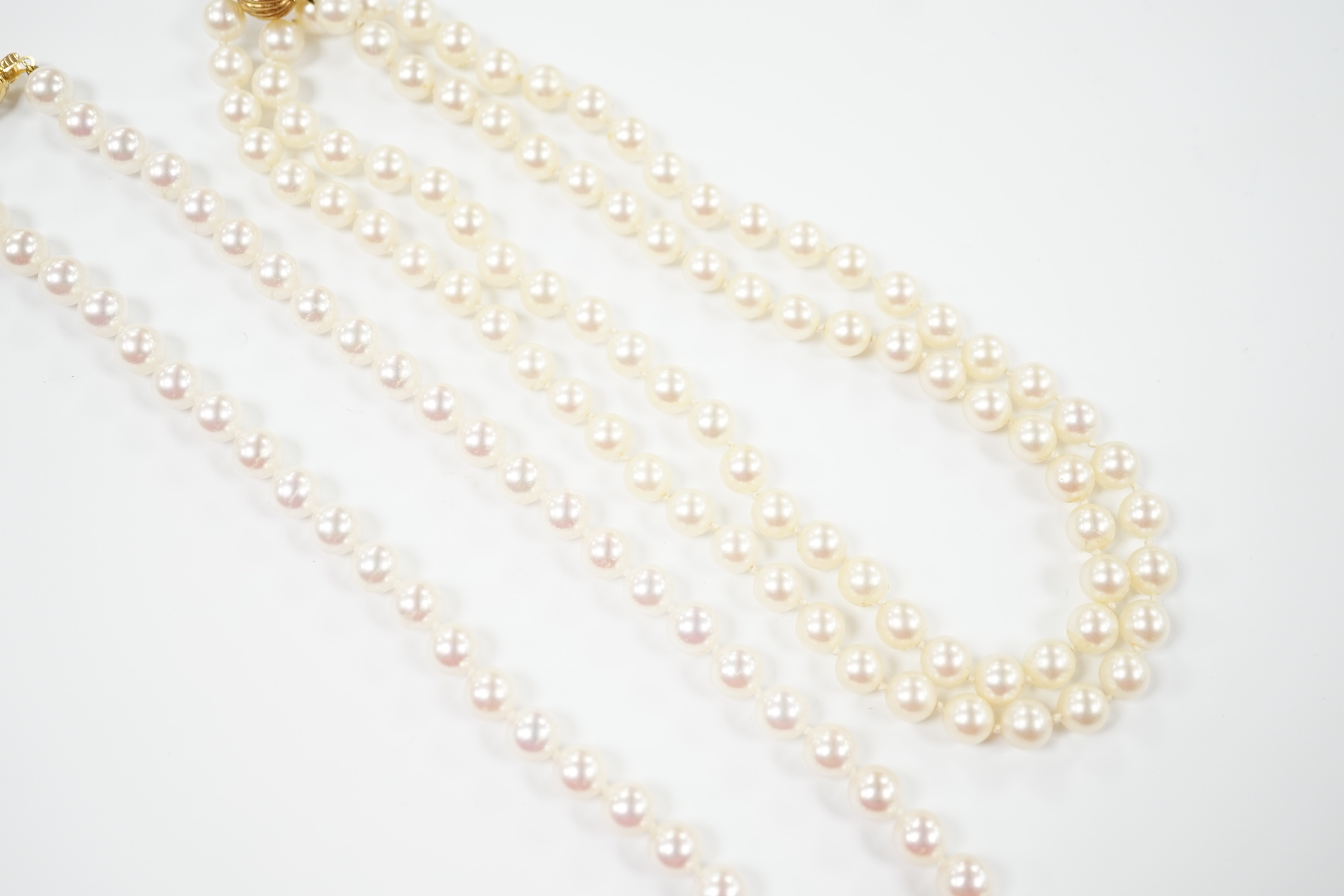 Two single strand cultured pearl necklaces, choker with 750 and diamond chip set clasp, 42cm, the other longer with 14k clasp, 72cm.